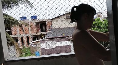 Wife works nude on balcony teasing her cuckold husband